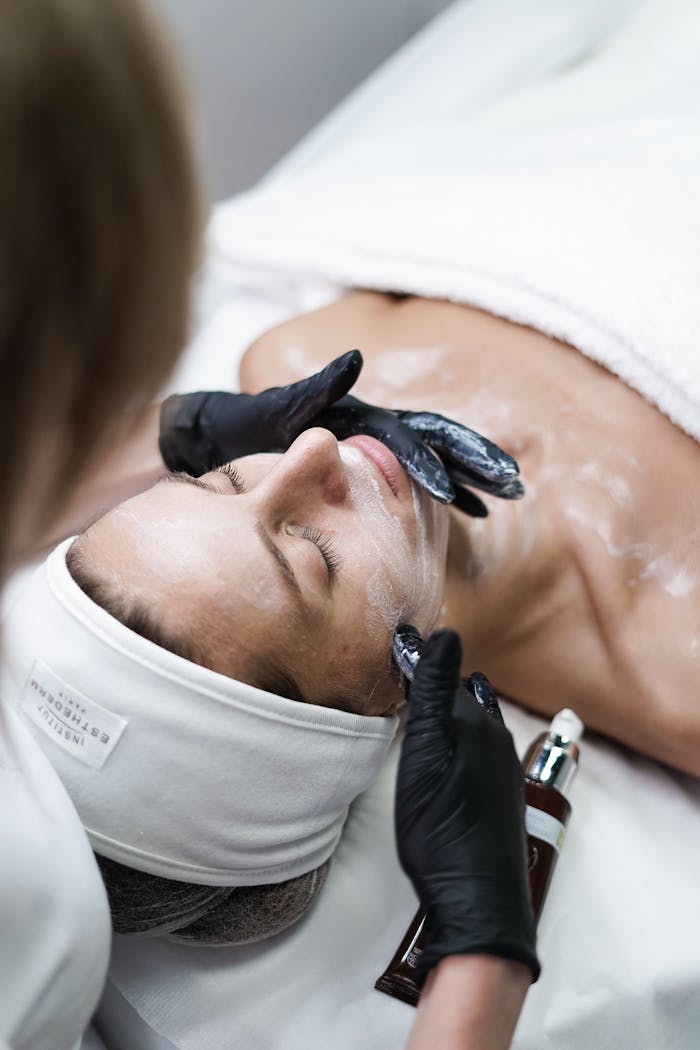 programs-03 A relaxing skincare session with a woman receiving a facial treatment at a spa.