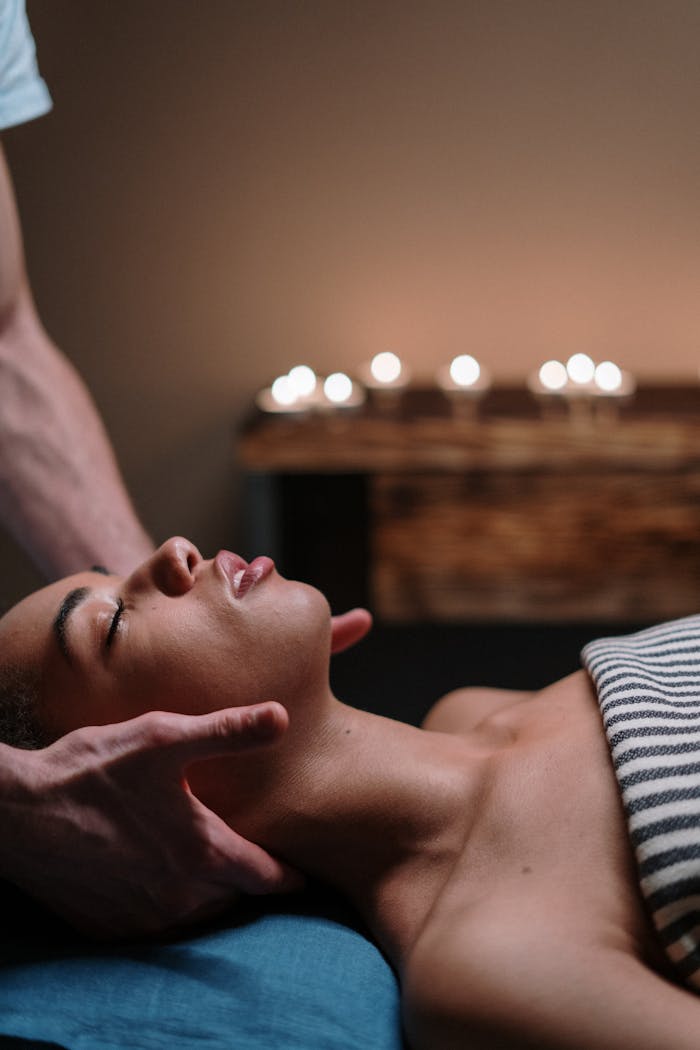 our-history-img A woman enjoying a relaxing face massage in a tranquil spa setting.